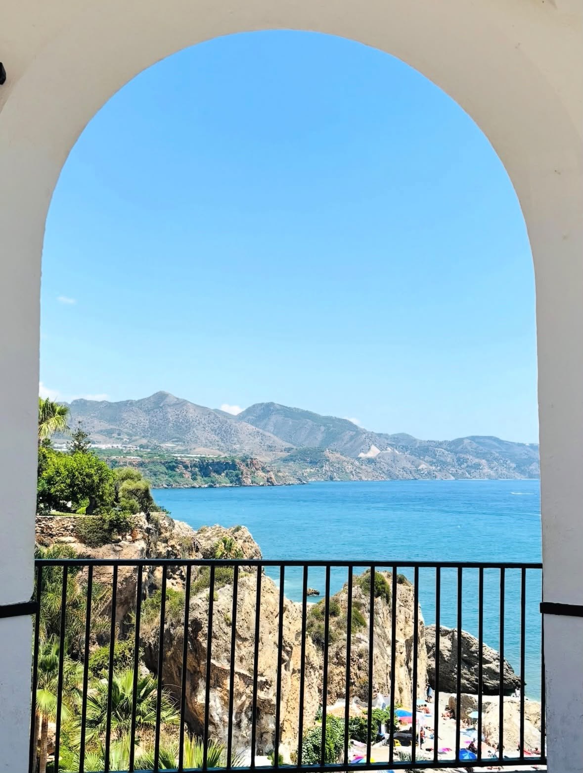 Sea and distant headlands framed by a white archway