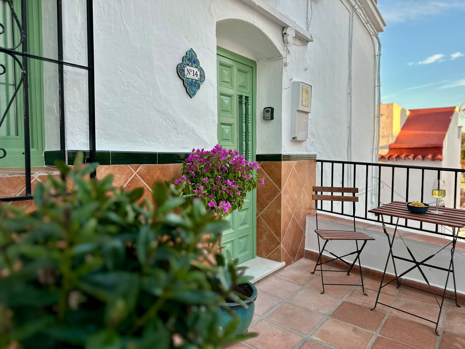 Sage green doors and a sunny seat outside No.14