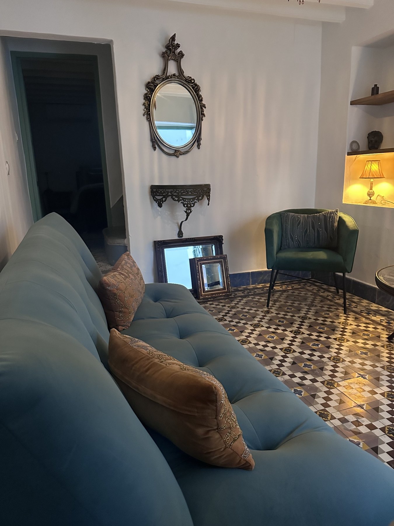Welcoming snug with green sofa and patterned floor