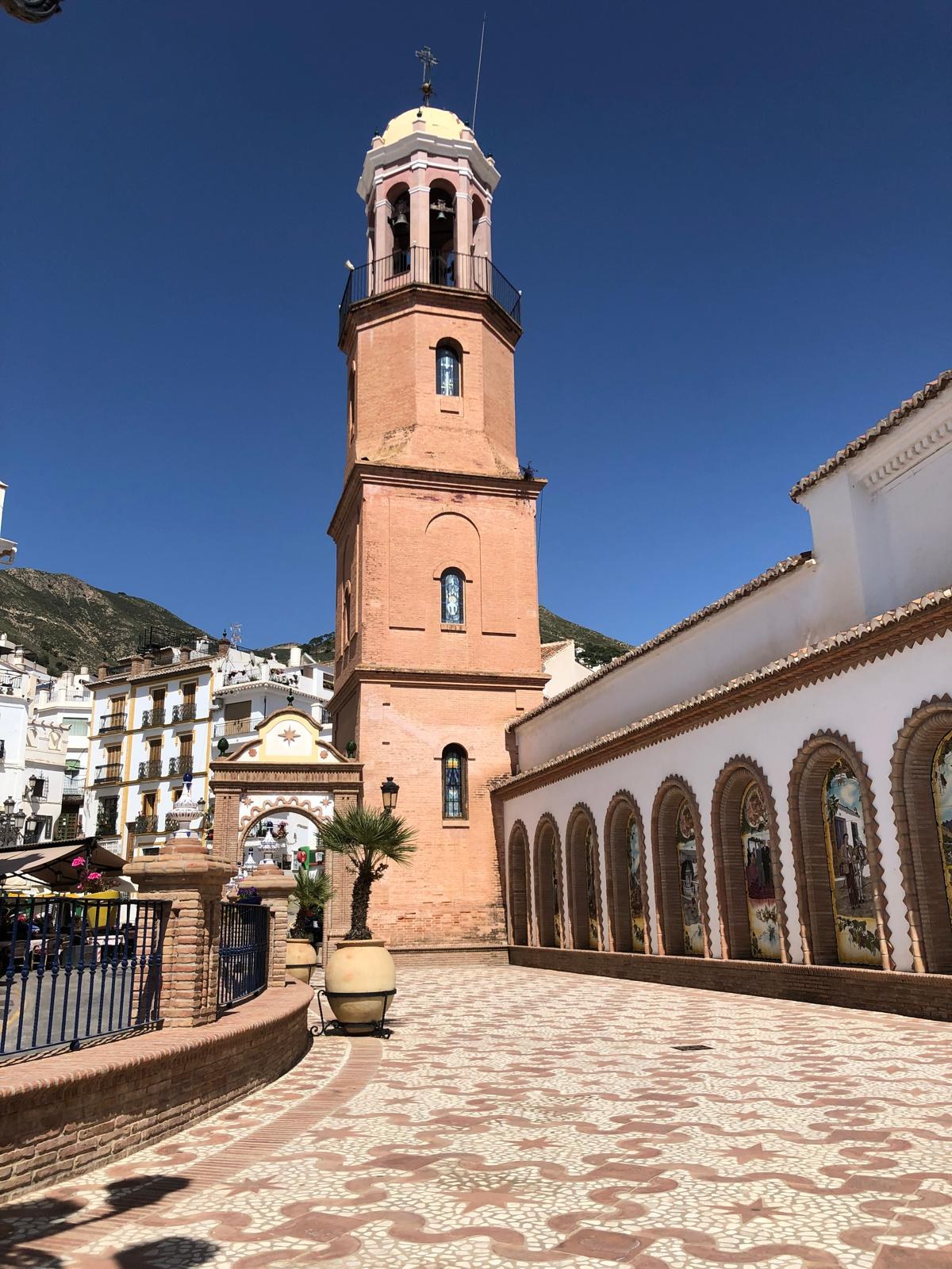Cómpeta’s church tower rising above the patterned square